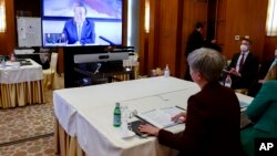 FILE - Australian Minister for Foreign Affairs, Penny Wong, right, talks via video link to Liu Jianchao, Minister of the International Department of the Chinese Communist Party Central Committee in Beijing, Dec. 21, 2022. 