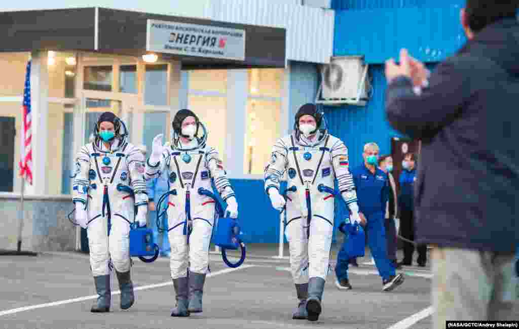 Expedition 64 NASA astronaut Kate Rubins, l, and Russian cosmonauts Sergey Ryzhikov, center, and Sergey Kud-Sverchkov, r, head to their launch onboard the Soyuz MS-17 spacecraft, at the Baikonur Cosmodrome in Kazakhstan. (Credit: NASA)
