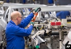 Workers complete car bodies at the plant of the German manufacturer Volkswagen AG in Zwickau, Germany, Jan. 22, 2018. President Trump vowed to tax European cars if the EU retaliates against his plans to tax imported steel and aluminum.