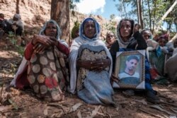 People mourn the victims of a massacre allegedly perpetrated by Eritrean soldiers in the village of Dengolat, North of Mekele, the capital of Tigray on Feb. 26, 2021.