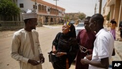 FILE - Zainab Sulaiman Umar, 26, center, a candidate for the State House of Assembly in Kumbotso constituency, Kano state, speaks to residents in Kano, northern Nigeria, Feb. 15, 2019.