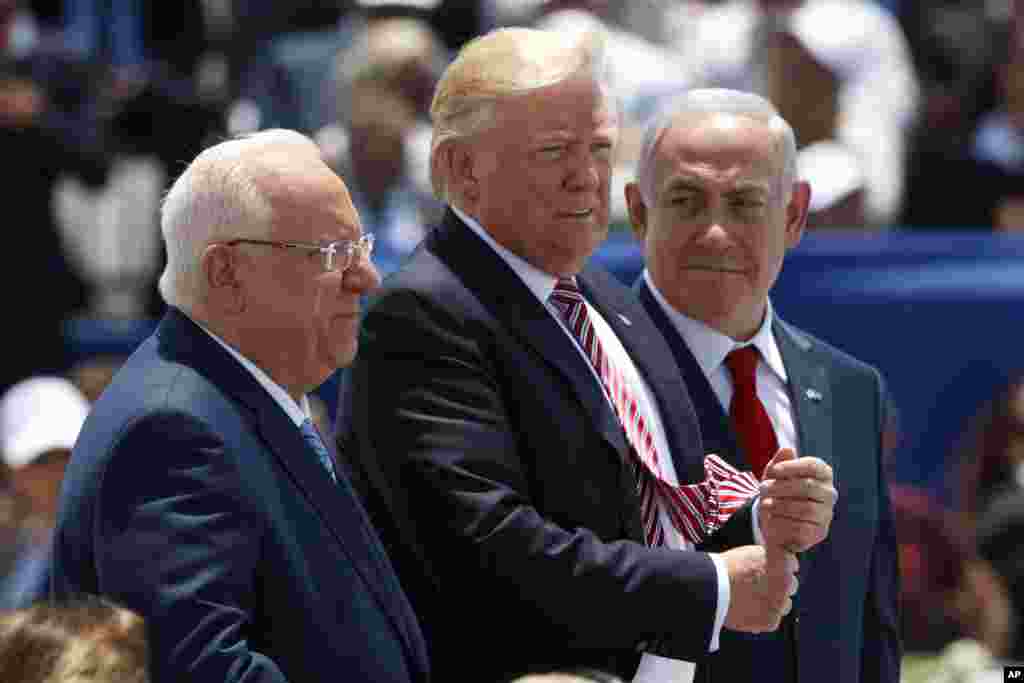 From left, Israeli President Reuven Rivlin, US President Donald Trump, and Israeli Prime Minister Benjamin Netanyahu listen during an arrival ceremony in honor of Trump, at Ben Gurion International Airport, May 22, 2017, in Tel Aviv. 