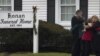 Mourners embrace outside a funeral home where services for six-year-old Jack Pinto, one of 20 schoolchildren killed in the December 14 shootings at Sandy Hook Elementary School, was being held in Newtown, Connecticut December 17, 2012. 