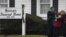 Mourners embrace outside a funeral home where services for six-year-old Jack Pinto, one of 20 schoolchildren killed in the December 14 shootings at Sandy Hook Elementary School, was being held in Newtown, Connecticut December 17, 2012. 