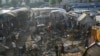 Palestinians look at the damage after an Israeli strike hit a tent area in the courtyard of Al Aqsa Martyrs hospital in Deir al Balah, Gaza Strip, Oct. 14, 2024. 