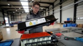 FILE - A used Lithium-ion car battery is opened before its dismantling by an employee of the German recycling firm Accurec in Krefeld, Germany, November 16, 2017. (REUTERS/Wolfgang Rattay/File Photo)