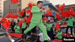 FILE - Chen Guangbiao, dressed in green respresenting is environmentalism, is seen at an event in Nanjing, Jiangsu province, Oct. 10, 2012.