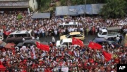 Supporters celebrate as election results are revealed on the screen in front of Myanmar's pro-democracy leader Aung San Suu Kyi's National League for Democracy (NLD) head office in Yangon April 1, 2012. 