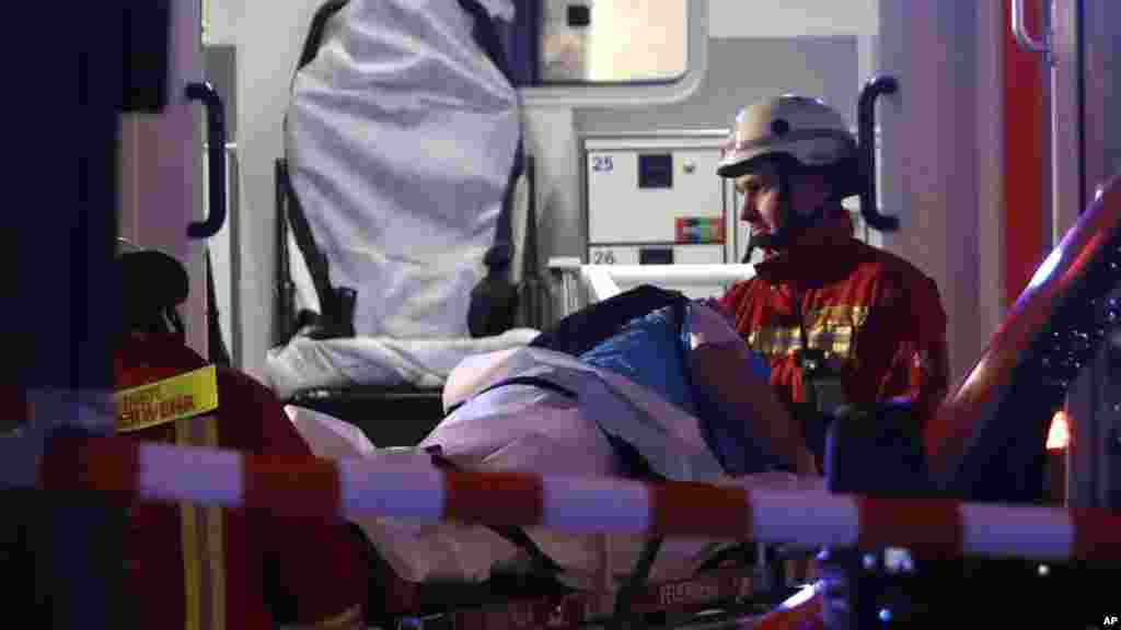 Des pompiers transportent un blessé dans une ambulance après qu’un camion a foncé dans un marché de Noël et tué plusieurs personnes à Berlin, Allemagne, 19 décembre 2016.