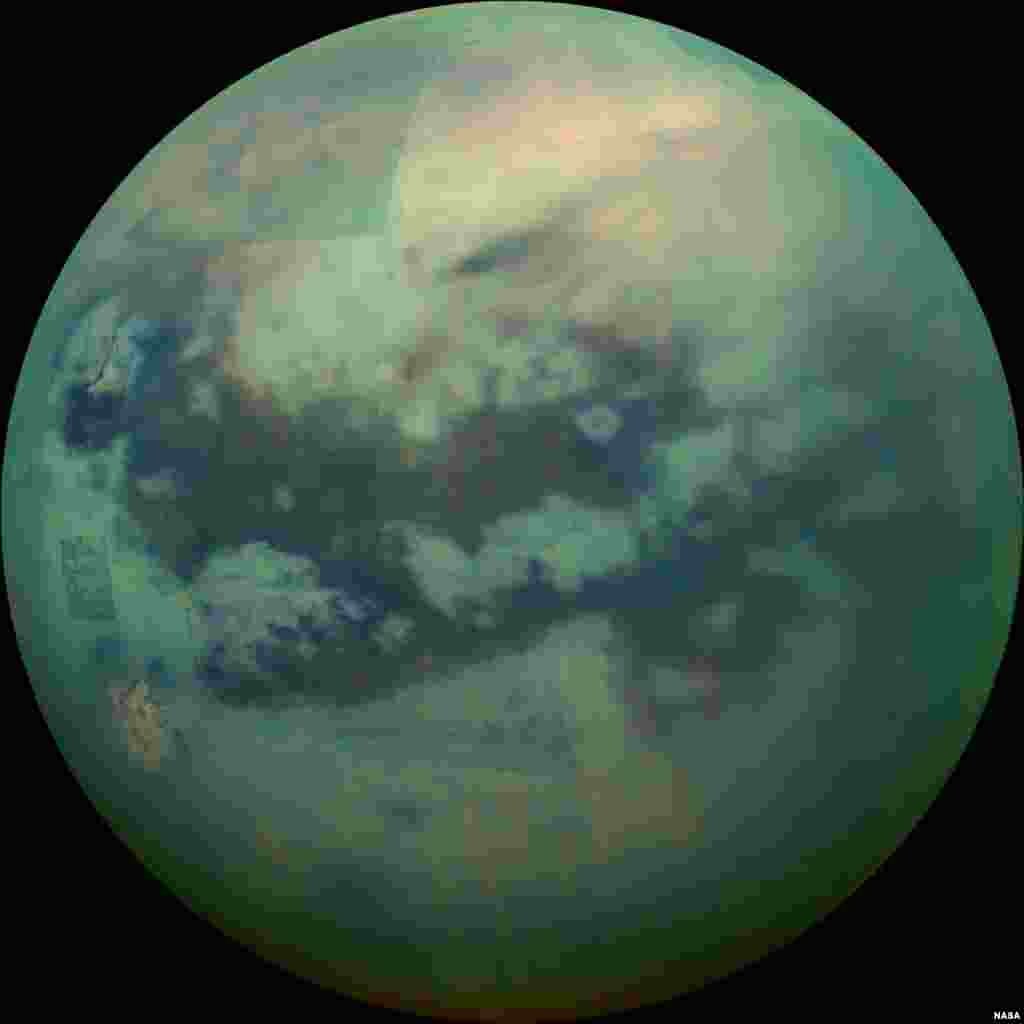 This Nov. 13, 2015 composite image made available by NASA shows an infrared view of Saturn&#39;s moon, Titan, as seen by the Cassini spacecraft. The near-infrared wavelengths in this image allow the cameras to penetrate the haze and reveal the moon&#39;s surface.