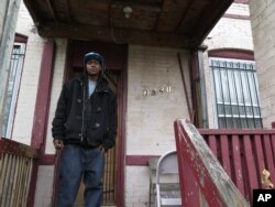 Craig House, 32, stands in front of his home in St. Louis, March 27, 2016.