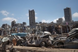 FILE - Damaged cars remain at the site of the Aug. 4 deadly blast in the port of Beirut that killed scores and wounded thousands, in Beirut, Lebanon, Aug. 17, 2020.