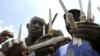 Ugandan traditional surgeons display circumcision knives before initiation ceremony, Mbale, Aug. 2008.