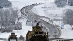 A convoy of Russian armored vehicles moves along a highway in Crimea, Jan. 18, 2022. Russia has concentrated an estimated 100,000 troops with tanks and other heavy weapons near Ukraine in what the West fears could be a prelude to an invasion.