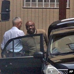 Nigerian ex-militant leader, Henry Okah (R) is led from the court in Johannesburg, 14 Oct 2010