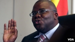 FILE: Zimbabwe's new finance minister Tendai Biti talks at a news conference in Harare Wednesday Feb. 18, 2009. Biti, now in charge of the country's finances said he had started paying civil servants in U.S. dollars, pledging to get a country crippled by