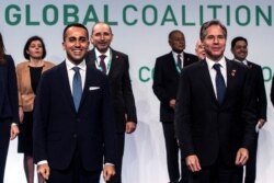 U.S. Secretary of State Antony Blinken, right, and Italian Minister of Foreign Affairs Luigi Di Maio, center, pose for a family photo as they host a meeting of US-led coalition against the Islamic State in Rome on June 28, 2021.