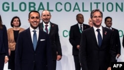 U.S. Secretary of State Antony Blinken, right, and Italian Minister of Foreign Affairs Luigi Di Maio, center, pose for a family photo as they host a meeting of US-led coalition against the Islamic State in Rome on June 28, 2021.