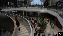 Shoppers make their way along the wide avenues inside the newly opened Mall of Africa in Midrand, South Africa, April 28, 2016.