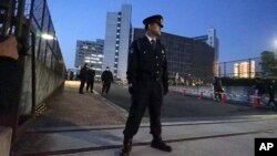 A police officer stands guard in front of Tokyo Detention Center, where former Nissan chairman Carlos Ghosn is detained, March 5, 2019, in Tokyo.