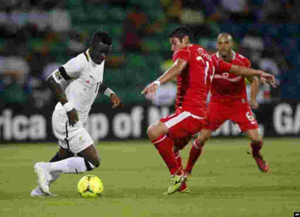 Ghana's Sulley Muntari (L) is challenged by Tunisia's Mejdi Traoui during their African Nations Cup quarter-final soccer match at Franceville stadium February 5, 2012.