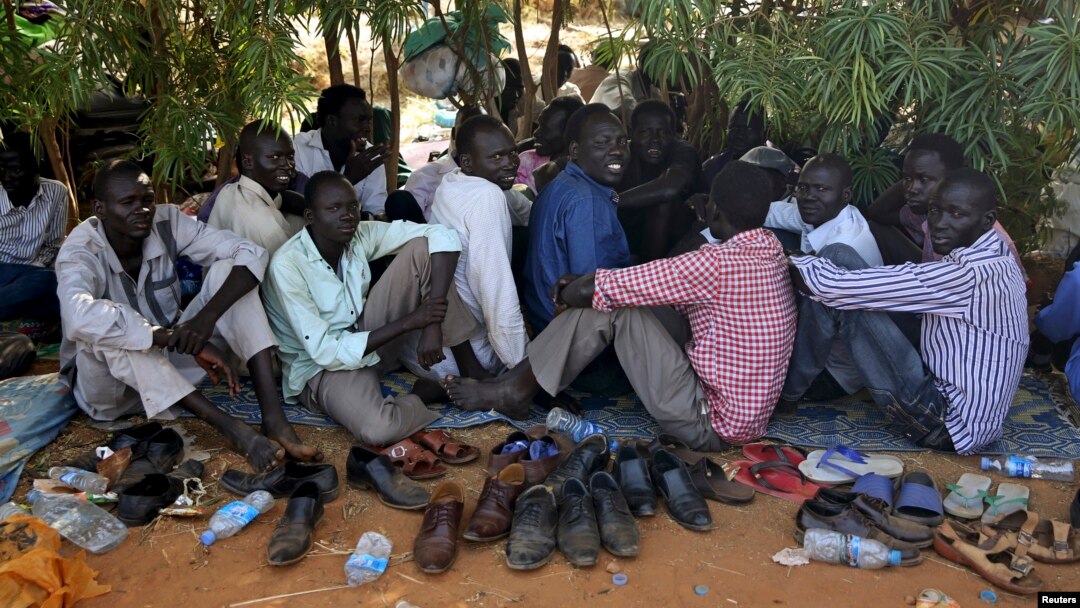 Internally displaced men sit inside a United Nations Missions in Sudan (UNMISS) compound in Juba December 19, 2013.