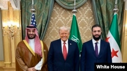 U.S. President Donald Trump, center, meets with Saudi Crown Prince Mohammed Bin Salman, left, and Interim Syrian President Ahmed al-Sharaa in Saudi Arabia, May 14, 2025.