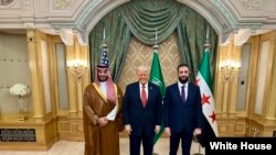 FILE -- U.S. President Donald Trump, center, meets with Saudi Crown Prince Mohammed Bin Salman, left, and Interim Syrian President Ahmed al-Sharaa in Saudi Arabia, May 14, 2025.