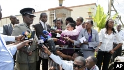 Kenyan Commissioner of Police Mathew Kirai Iteere, left, addresses media on the weekend attack on the police officers in Samburu, northwestern Kenya at Wilson Airport in Nairobi, Nov. 13, 2012.