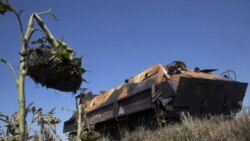 A pro-Russian fighters' APC stands abandoned near the city of Lisichansk, Luhansk region, eastern Ukraine Saturday, July 26, 2014.