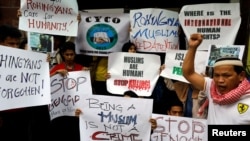 Filipino Muslims display placards during a rally to protest Myanmar's persecution of Rohingya Muslims outside Myanmar's embassy in Makati, Metro Manila, Philippines, Sept. 8, 2017.