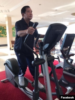 Hun Sen works out on a treadmill.