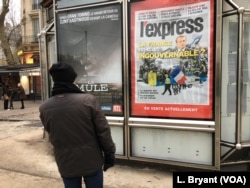 A Parisian looks at a newspaper billboard on France's current political dilemmas.