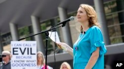 FILE - Rape survivor and abuse victim advocate Mary DeMuth speaks during a rally protesting the Southern Baptist Convention's treatment of women outside the convention's annual meeting at the Kay Bailey Hutchison Convention Center in Dallas. 