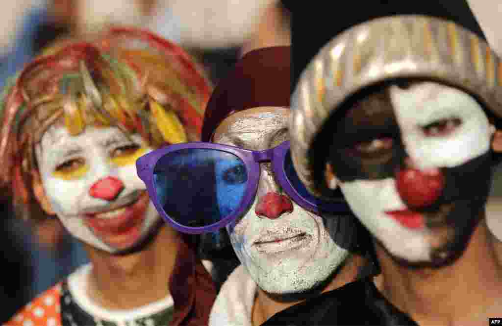 Palestinians dressed as clowns pose for a picture during an event for children organized by the Pink Panther group to mark the day of the Palestinian clown, at the seaport in Gaza City.