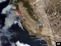 This Oct. 9, 2017, satellite image from the National Oceanic and Atmospheric Administration shows smoke from several fires, noted in red, burning in California, with winds generally blowing from east to west. From the top are the Tubbs and other fires in the Santa Rosa and Napa Valley wine country north of the San Francisco Bay area, top left, several smaller fires in the Sierra Nevada, right center to lower right, and the Canyon 2 fire in Orange County east of Los Angeles, bottom.