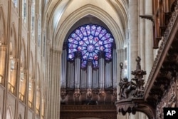 Jendela kaca patri mawar di katedral Notre-Dame de Paris yang telah dipugar, saat ditinjaui oleh Presiden Prancis Emmanuel Macron, 29 November 2024.