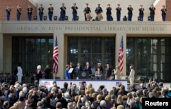 FILE - (L-R) U.S. First lady Michelle Obama, former first lady Barbara Bush, former first lady Laura Bush, President Barack Obama, former President George W. Bush, former President Bill Clitnon, former President George H.W. Bush, former President Jimmy Carter, former first lady Hillary Clinton, and former first lady Rosalynn Carter arrive at the dedication for the George W. Bush Presidential Center on the campus of Southern Methodist University in Dallas, Texas, April 25, 2013.