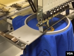 An embroidery machine operates at printer Luis Bustos' shop, Print and Save, in Indianapolis. He says he was able register the shop's name and get his business license quickly, arrange for office space in one interview and begin paying back his initial investment within three months. (C. Presutti/VOA)