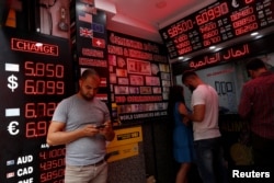 People change money at a currency exchange office in Istanbul, Turkey, Aug. 17, 2018.