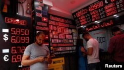 People change money at a currency exchange office in Istanbul, Turkey, Aug. 17, 2018.