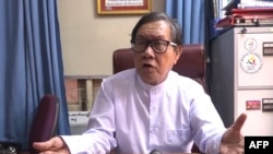 This screengrab provided via AFPTV video footage taken on April 12, 2021 shows Khin Maung Zaw, lawyer for Aung San Suu Kyi who was detained in the February military coup, as he speaks to the media in an office in Naypyidaw. (Photo by - / AFPTV / AFP)