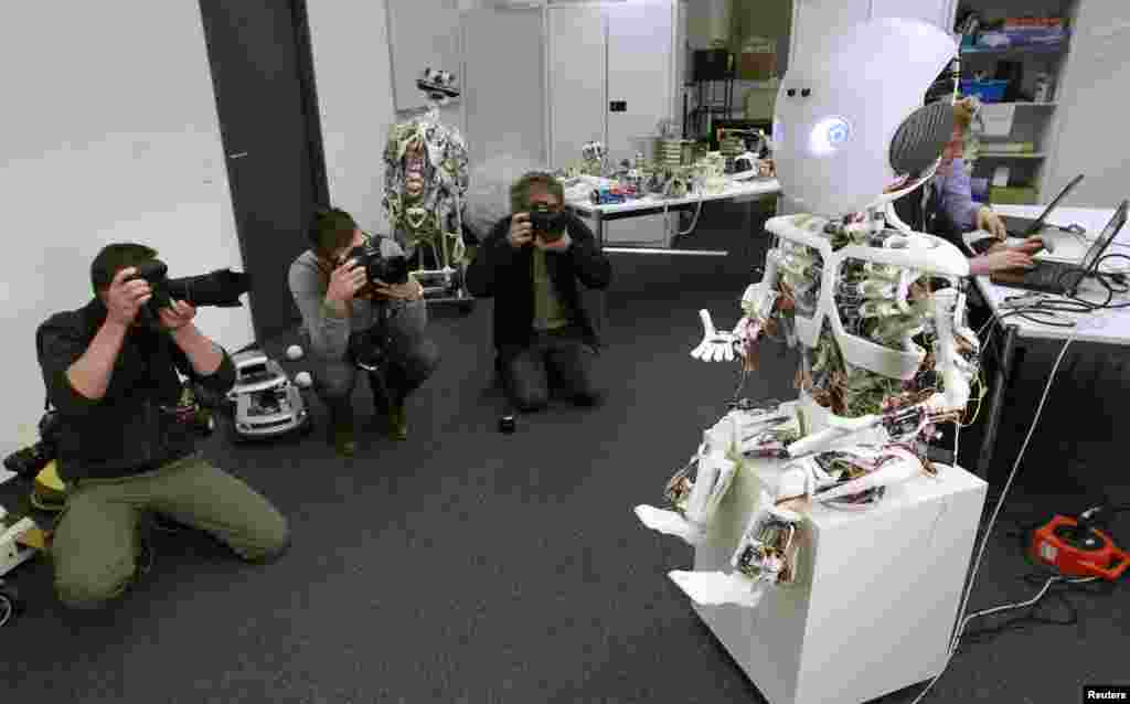 Photographers take pictures of the humanoid robot ROBOY during a media presentation at the Artificial Lab of the University of Zurich in Zurich, Switzerland. 