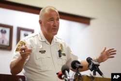 St. Louis County Police Chief Jon Belmar calls the Sunday night violence 'an impediment to positive change.' He's speaking at a news conference in Clayton, Missouri, Aug. 10, 2015.
