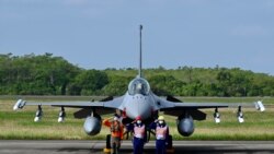 Taiwan Air Force staffers salute in front of an upgraded US-made F-16 V fighter during a ceremony at the Chiayi Air Force in southern Taiwan on Nov. 18, 2021. 