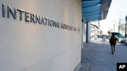 FILE - The International Monetary Fund (IMF) headquarters is seen, Dec. 19, 2016, in Washington. 