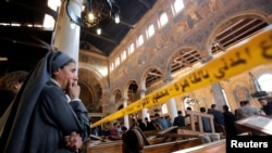 A nun cries as she stands at the scene inside Cairo's Coptic cathedral, following a bombing in Egypt, Dec. 11, 2016.