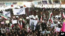 Iranians take part in the funeral of Sanee Zhaleh, a student who was shot dead during an opposition rally on in Tehran, February 16, 2011