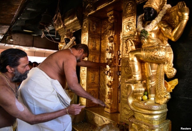 A priest closes the doors of sanctorum for performing religious rituals following the entry of two women in Sabarimala temple in Pathanamthitta, India, Jan. 2, 2019.