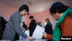 People vote at a polling station during the presidential election in Tbilisi, Georgia, Oct. 28, 2018.